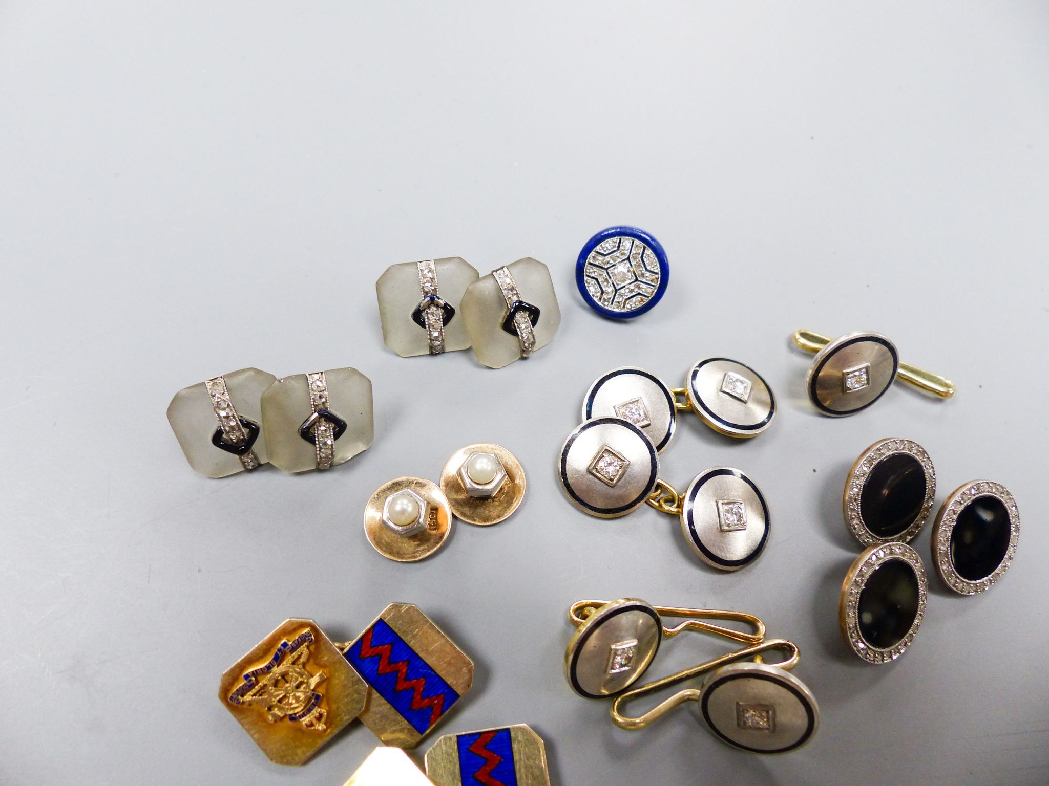 A pair of yellow and white metal, diamond and black enamel cufflinks and three similar dress studs, 11mm, one stamped 14k, gross 21.9 grams, four frosted glass, black enamel and diamond set dress studs(a.f.), two 15ct &